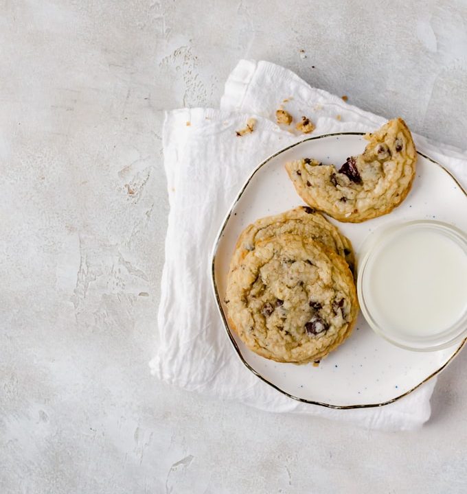 Plate of coconut chocolate chip cookies with a glass of milk