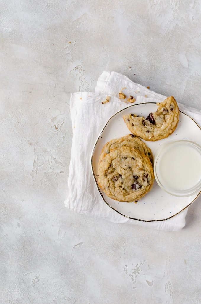 Plate of coconut chocolate chip cookies with a glass of milk