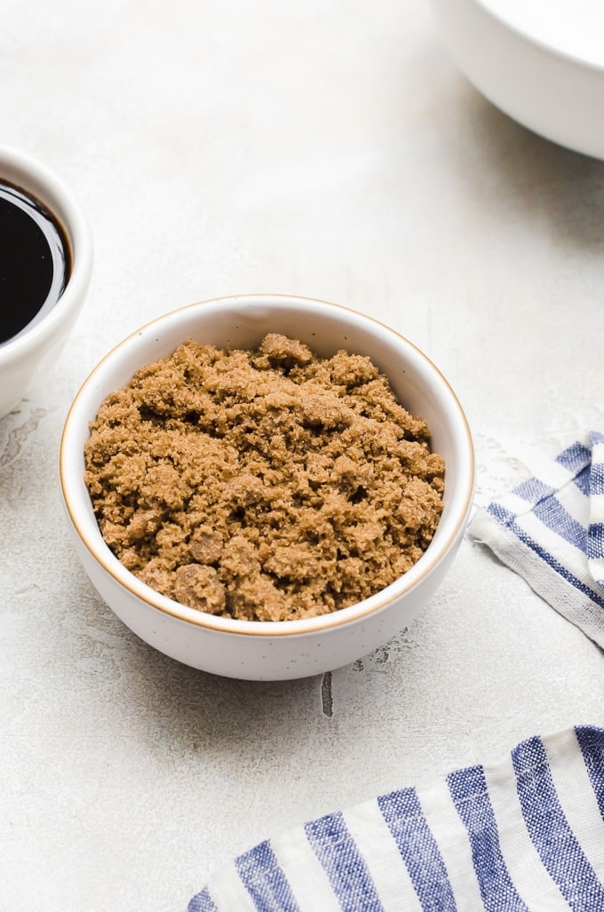 bowl of sugar on table next to molasses