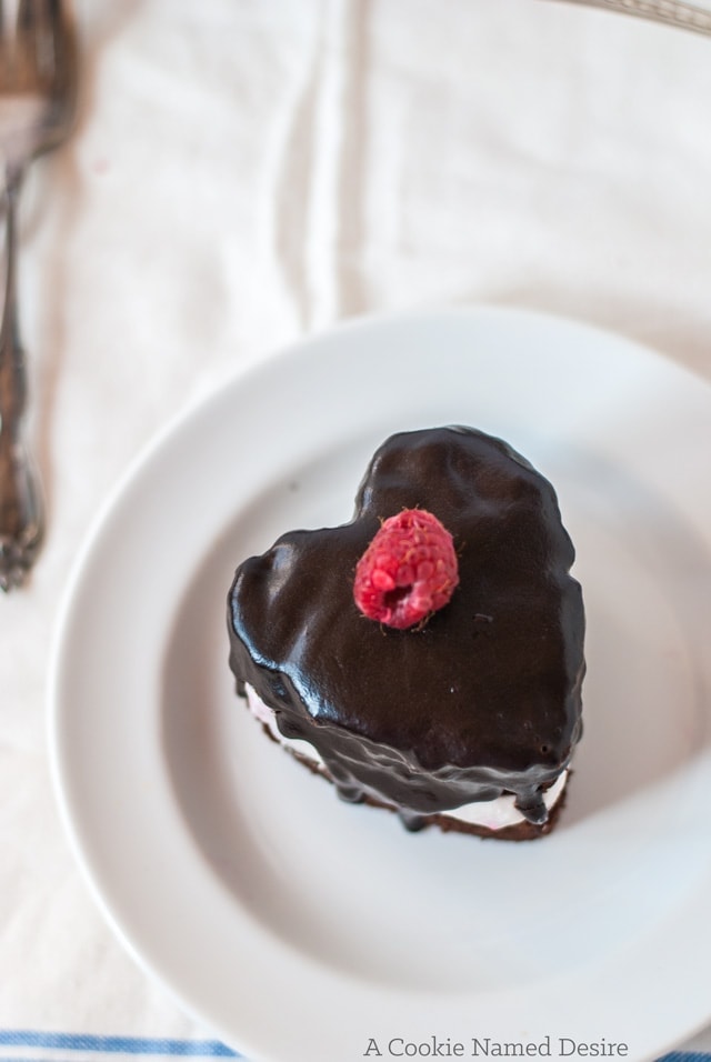 Mini heart-shaped chocolate cakes with fresh raspberry whipped cream and chocolate ganache