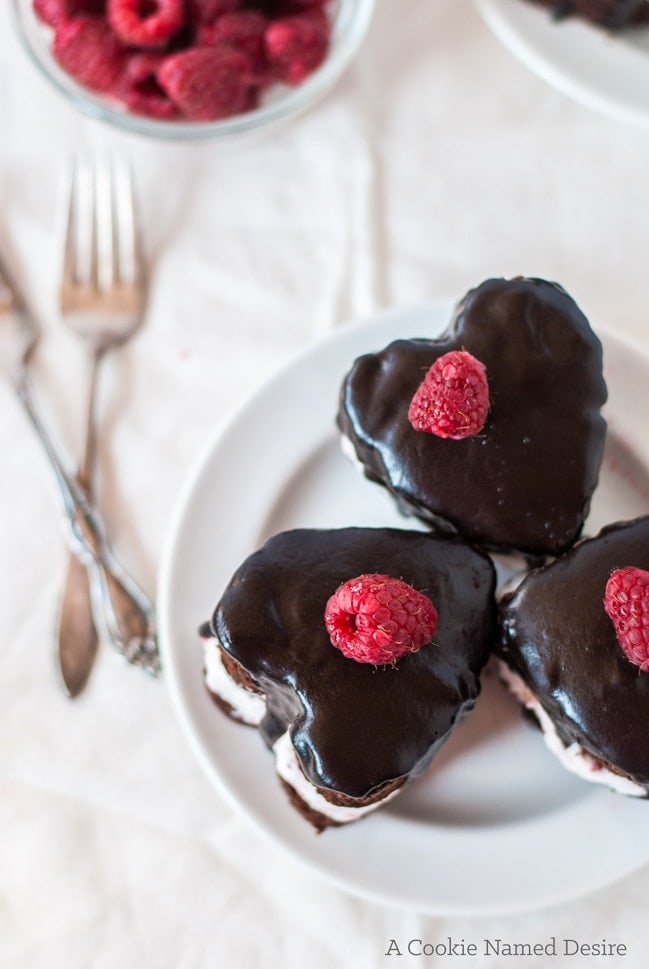 Mini heart-shaped chocolate cakes with raspberry whipped cream - the perfect romantic dessert