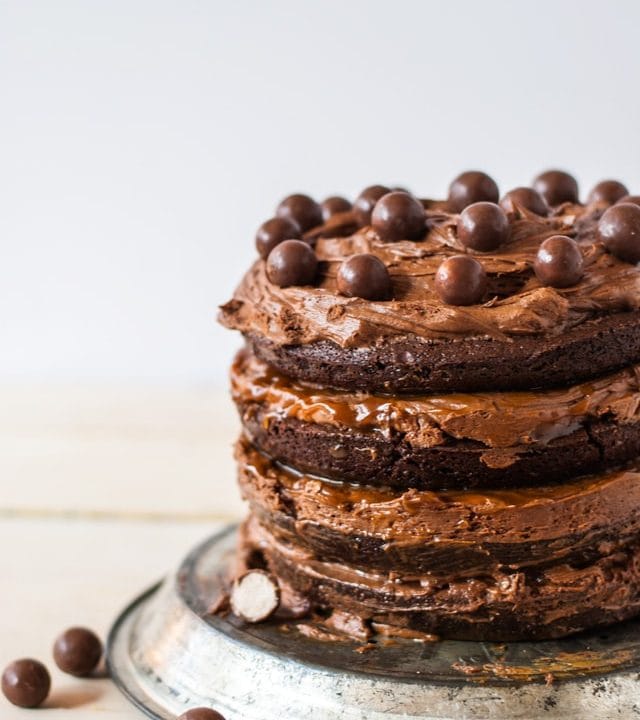 A rich, fudgy brownie cake with chocolate malt frosting and caramel sauce