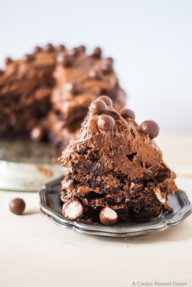 An incredibly epic brownie cake with a ton of silky chocolate malt frosting and caramel sauce