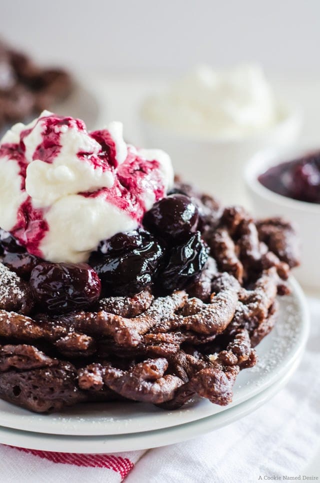 Black forest funnel cake - a delicious chocolate funnel cake with cherry compote, and fresh whipped cream
