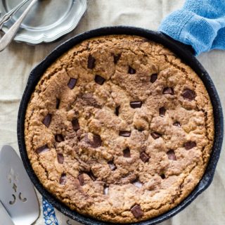 A giant chocolate chip skillet cookie with a hidden layer of gooey melted chocolate