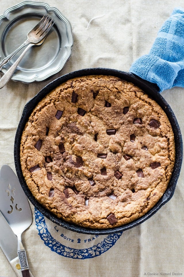 A giant chocolate chip skillet cookie with a hidden layer of gooey melted chocolate