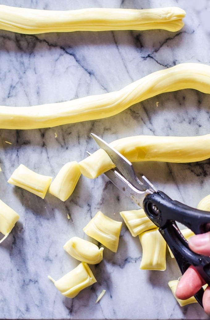 Hand cutting taffy pieces