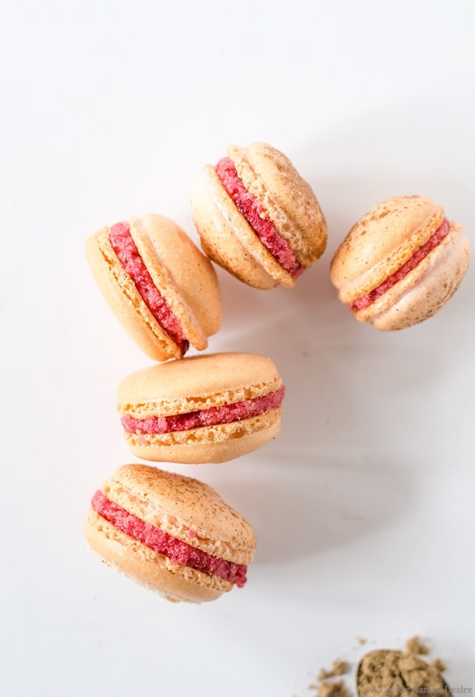 Mulled cranberry macarons. These deliciously delicate cookies are dusted with cardamom and cinnamon, then filled with a light mulled cranberry buttercream, 