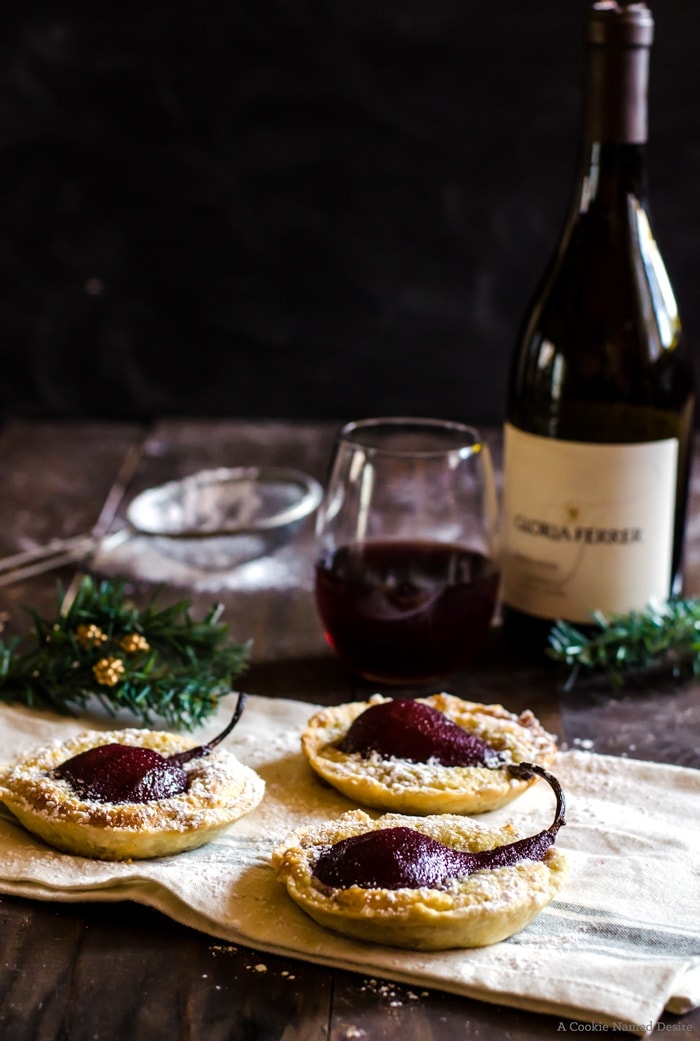 Wine poached pear tarts make a great holiday party dessert to pair with your favorite pinot noir
