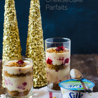 A creamy vegan no-bake cheesecake parfait with cranberry swirl and gingersnap crumble