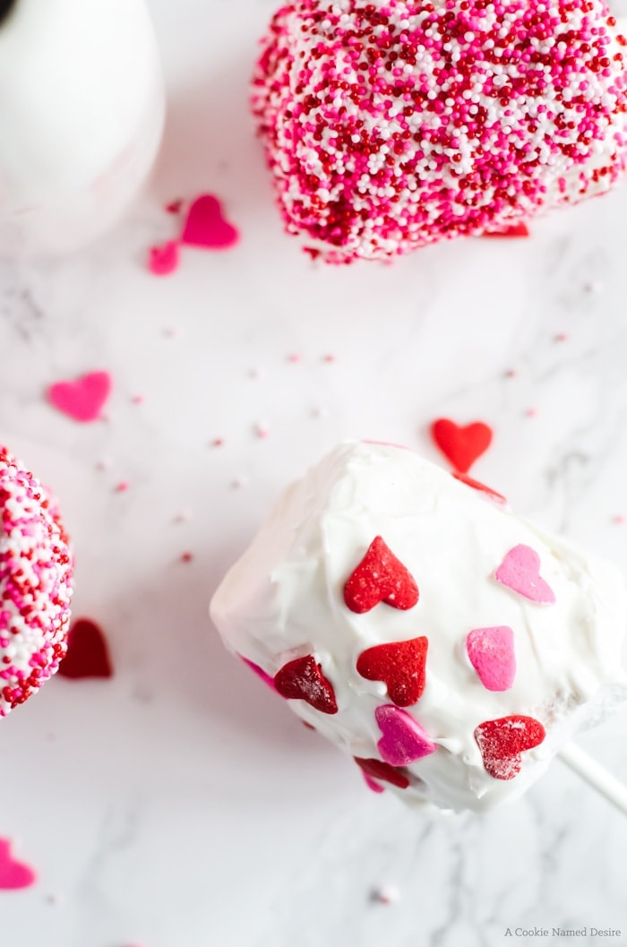 Homemade marshmallow pops covered in white chocolate and covered in sprinkles