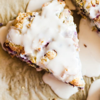 Tender mixed berry scones filled with blueberries, blackberries, raspberries, and strawberries then topped with a sweet vanilla glaze. Berry scones like these make excellent treats for breakfast, brunch, or with tea.