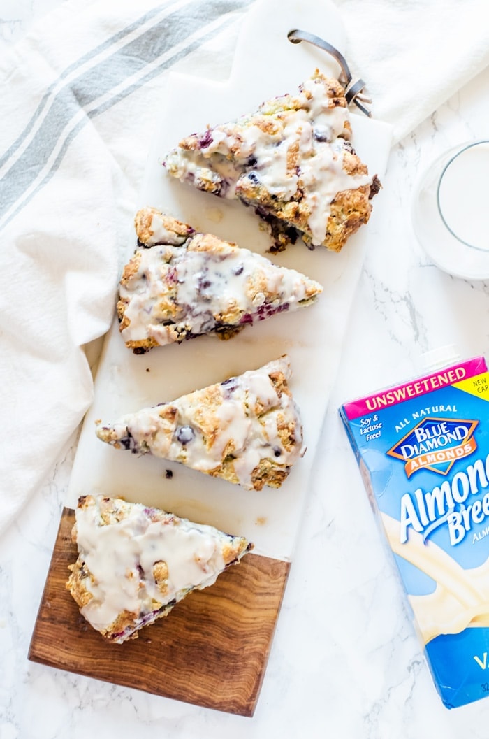 Tender mixed berry scones filled with blueberries, blackberries, raspberries, and strawberries then topped with a sweet vanilla glaze. Berry scones like these make excellent treats for breakfast, brunch, or with tea. 