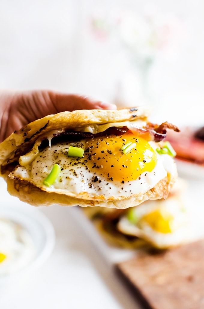 These American breakfast tacos are the perfect on-the-go way to get a full breakfast food truck style. Light and fluffy pancakes act as a vehicle for thick slices of bacon, melted cheese, and fried eggs. Smother the whole thing in maple syrup and you have the best breakfast ever!