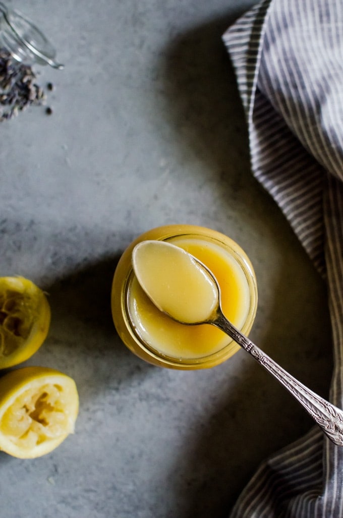 Close up of curd in spoon on jar