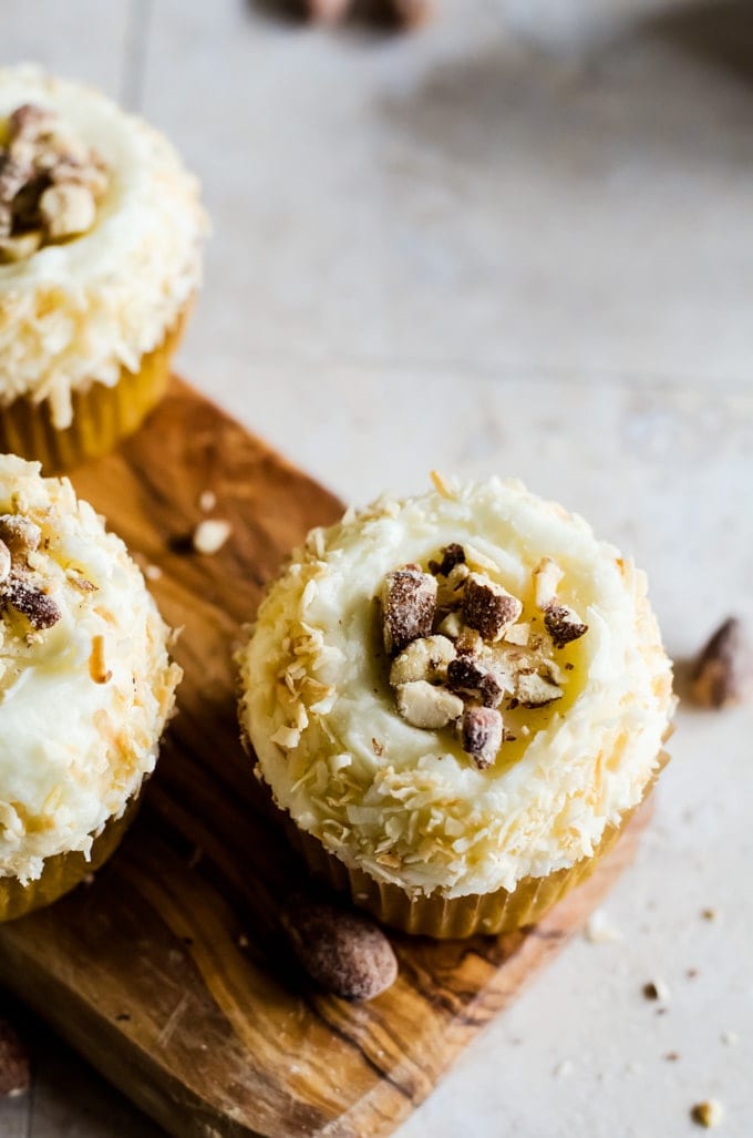 These light coconut cupcakes with coconut flavored almonds are the perfect summer treat. They are so easy to make and are a crowd pleasing favorite!