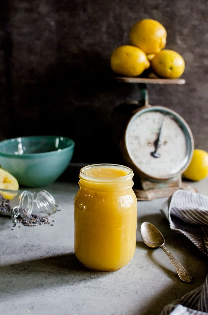 Curd in jar surrounded by lemons 
