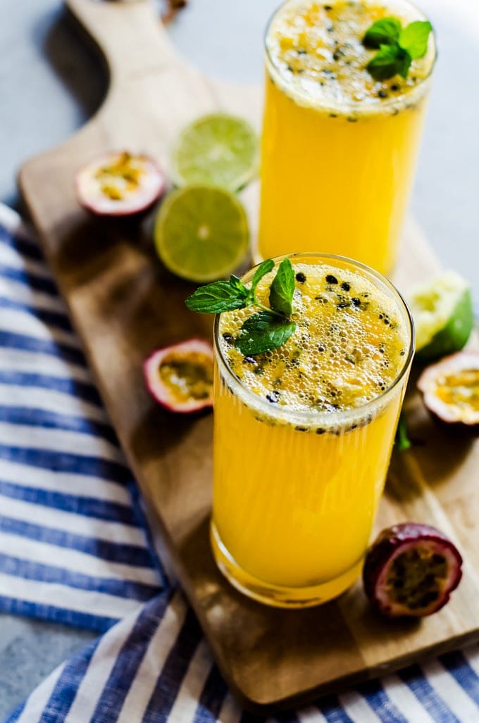 passion fruit mojito on cutting board with mint and lime 