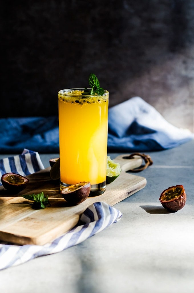 passion fruit mojito with glass on cutting board