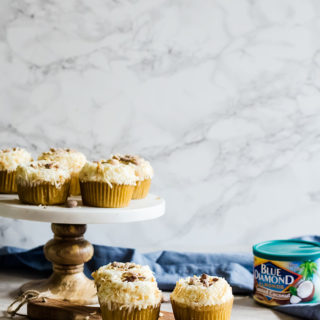 These light coconut cupcakes with coconut flavored almonds are the perfect summer treat. They are so easy to make and are a crowd pleasing favorite!