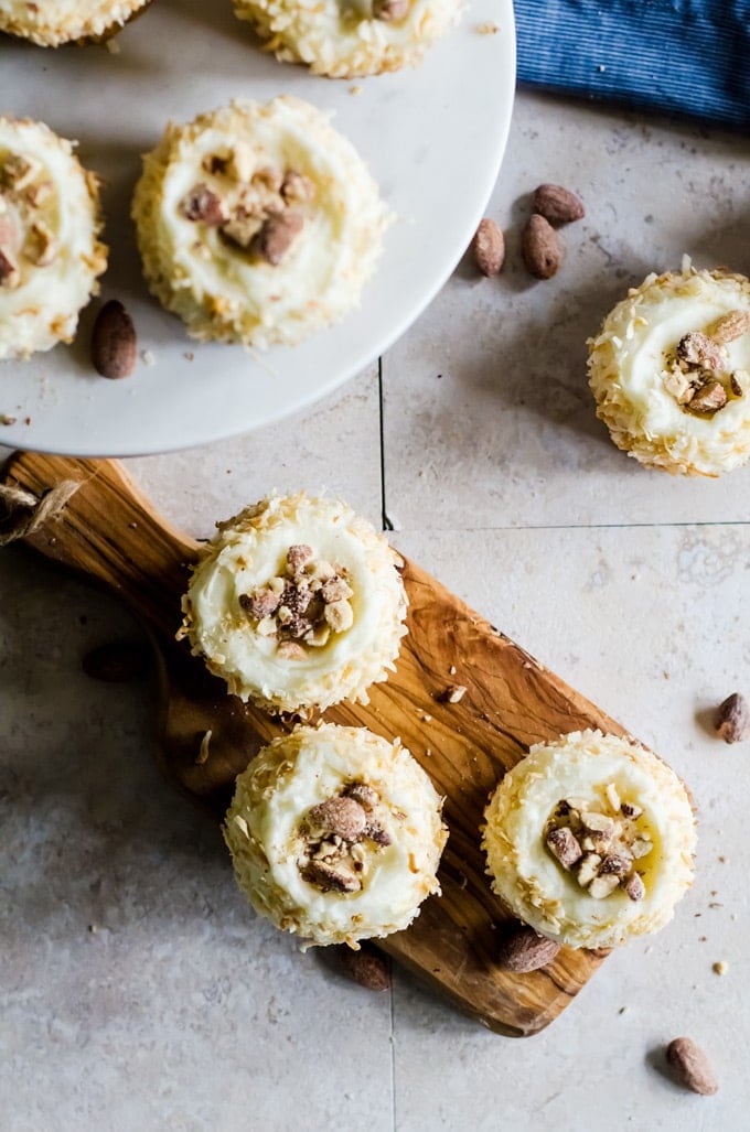 These light coconut cupcakes with coconut flavored almonds are the perfect summer treat. They are so easy to make and are a crowd pleasing favorite!