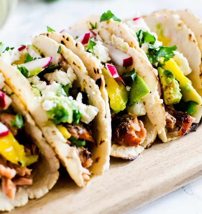 Grilled salmon tacos with a refreshing avocado mango salsa. If you only make one thing on the grill this summer, it has to be this.