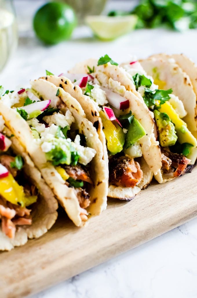 Grilled salmon tacos with a refreshing avocado mango salsa. If you only make one thing on the grill this summer, it has to be this.