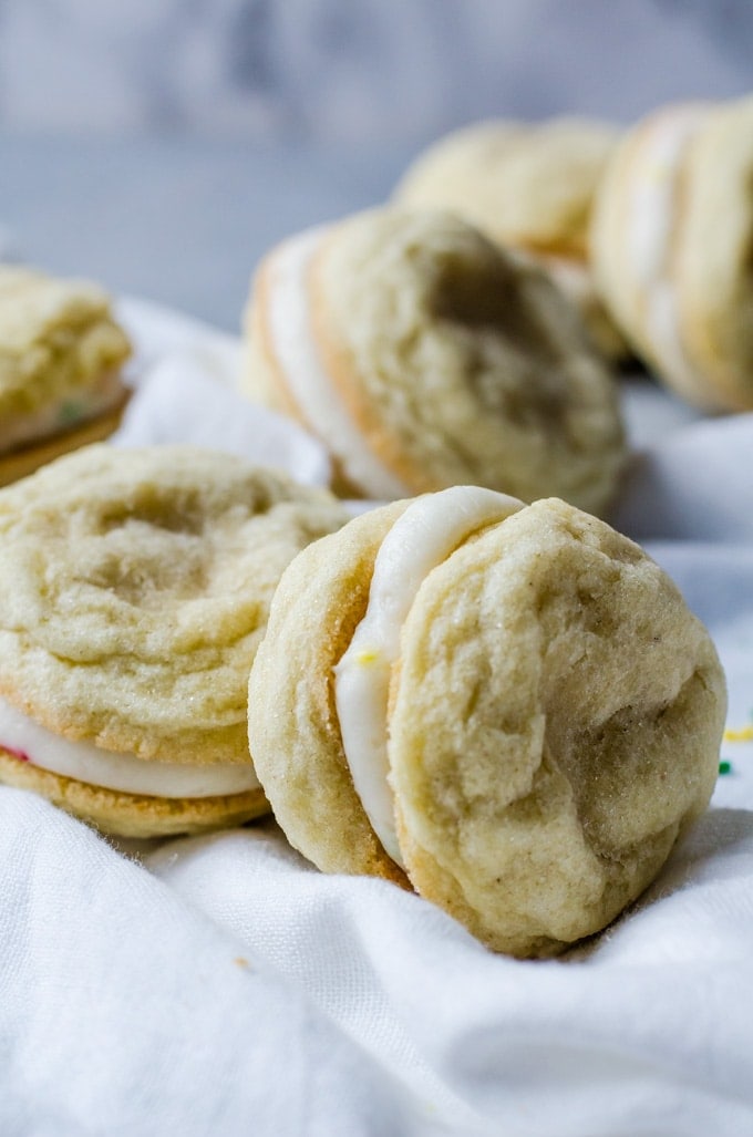 Everyone is going to fall in love with these lemon sandwich cookies filled with cake batter frosting. These are the tastiest way to eat cookies! 