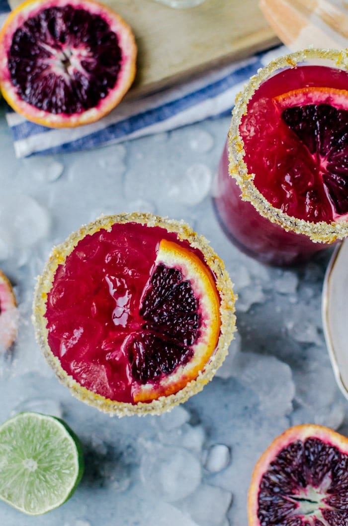 close up overhead blood orange margarita in glasses with blood orange slice