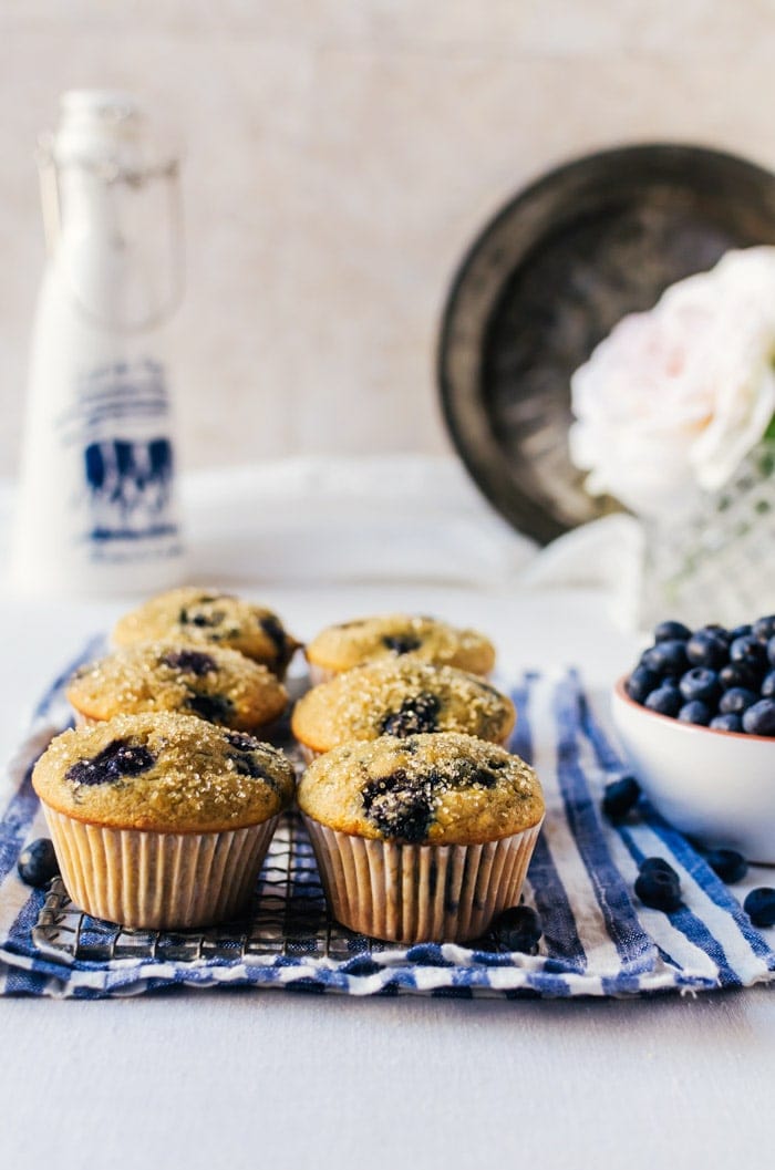 healthy blueberry muffins on wire rack on top of kitchen towel