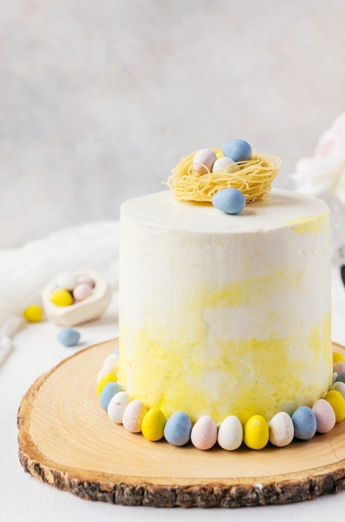 A tasty malt cake with white chocolate swiss meringue buttercream topped with cute chocolate Easter eggs