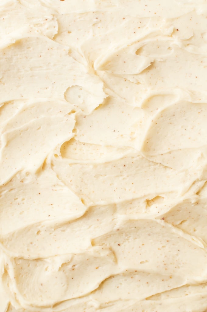 close up brown butter frosting with flecks of brown butter