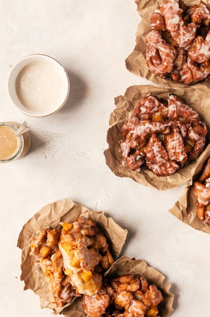 Irresistible peach fritters with maple glaze. There is nothing better than waking up to one of these in the morning