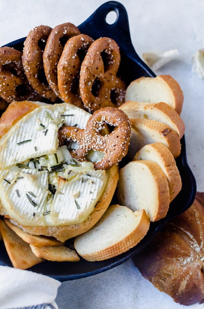 Rosemary garlic baked brie inside a crusy loaf of bread is the answer to all your appetizer woes