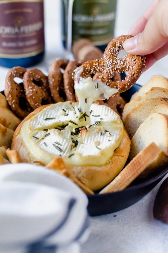 There isn't anything better than warm, gooey rosemary garlic baked brie inside a crusty loaf of bread. 