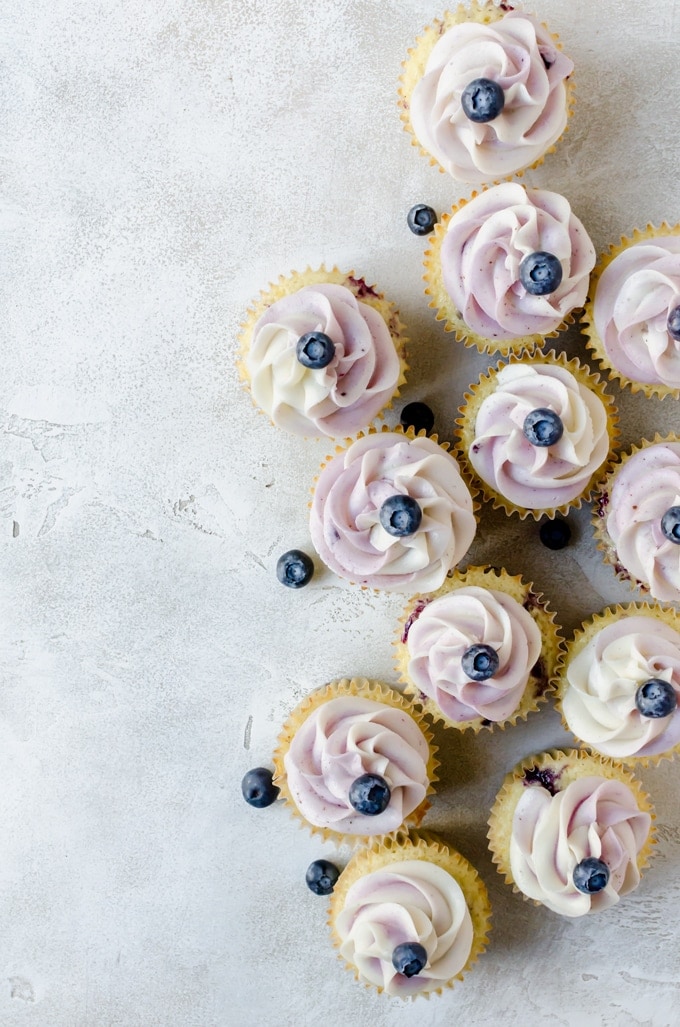 scattered lemon blueberry cupcakes overhead