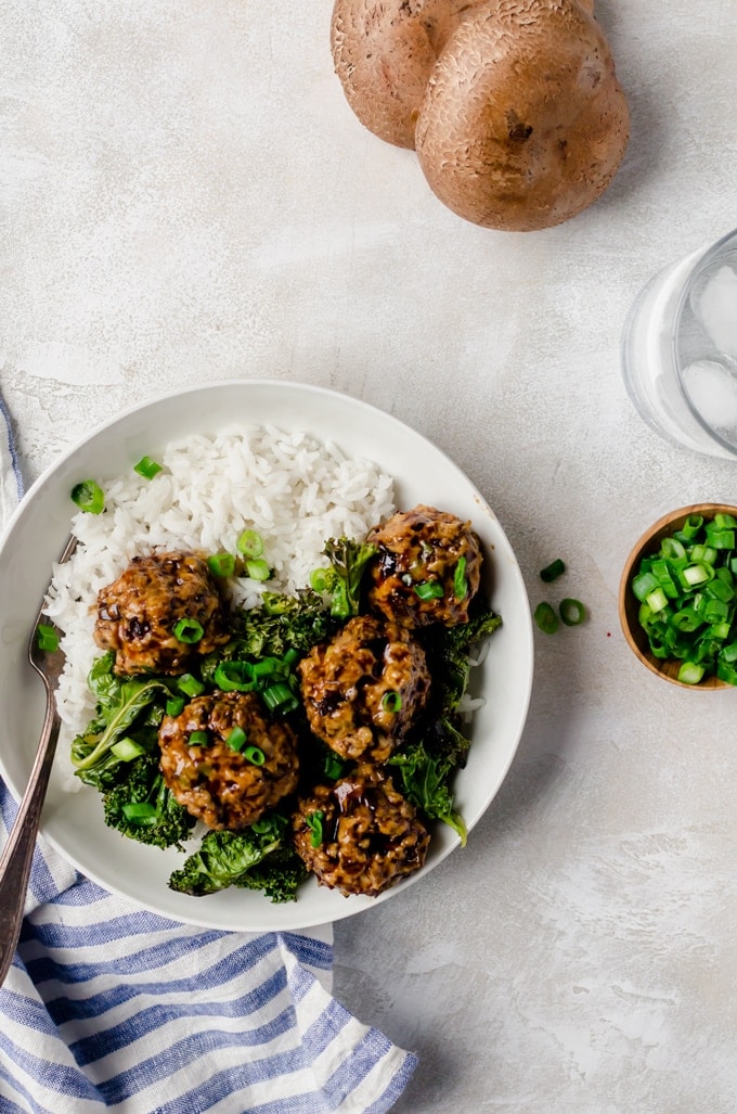 Overhead shot of Tsukune Japanese Chicken Meatballs with coconut rice and kale in a bowl 