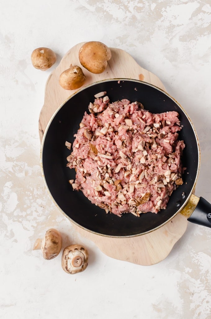 Ground turkey in skillet with chopped mushrooms