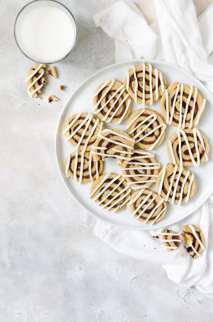 cookies on plate next to glass of milk