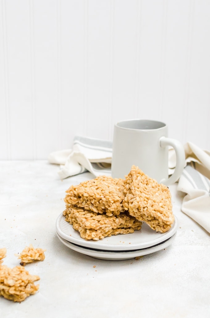 coffee rice crispy treats stacked on a plate with a mug of coffee