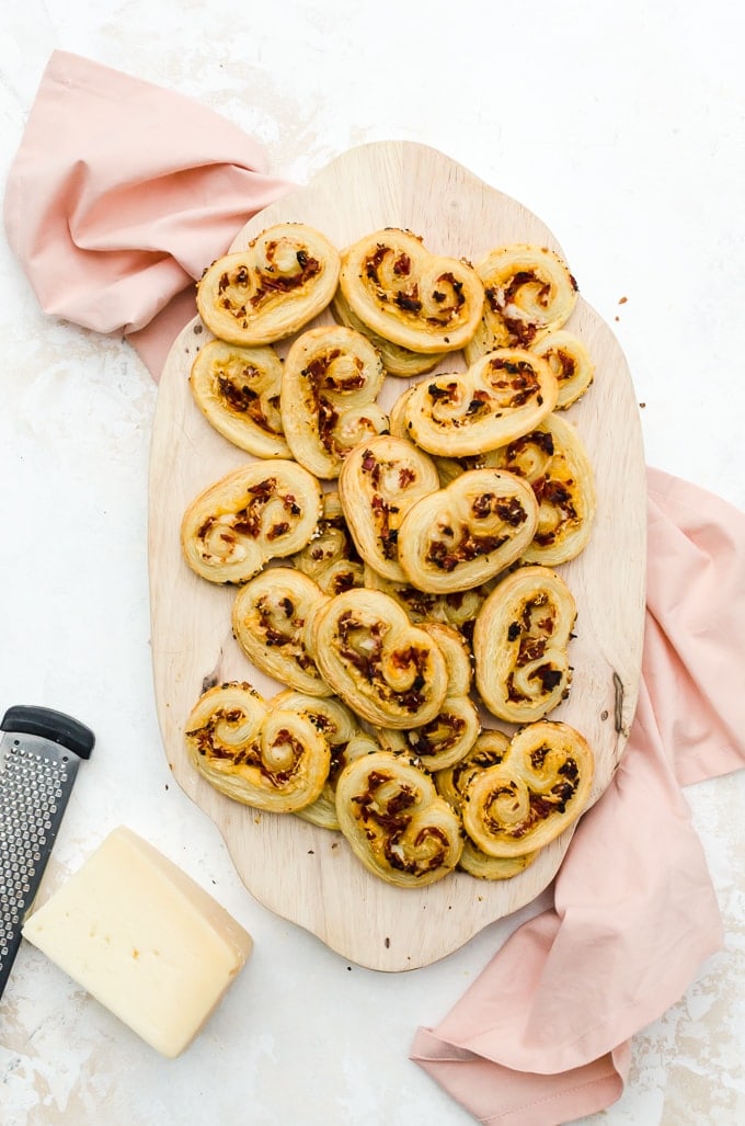 Overhead savory palmiers party appetizer on board