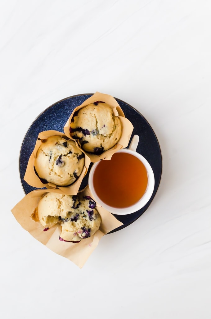 blueberry doughnut muffins on plate with tea