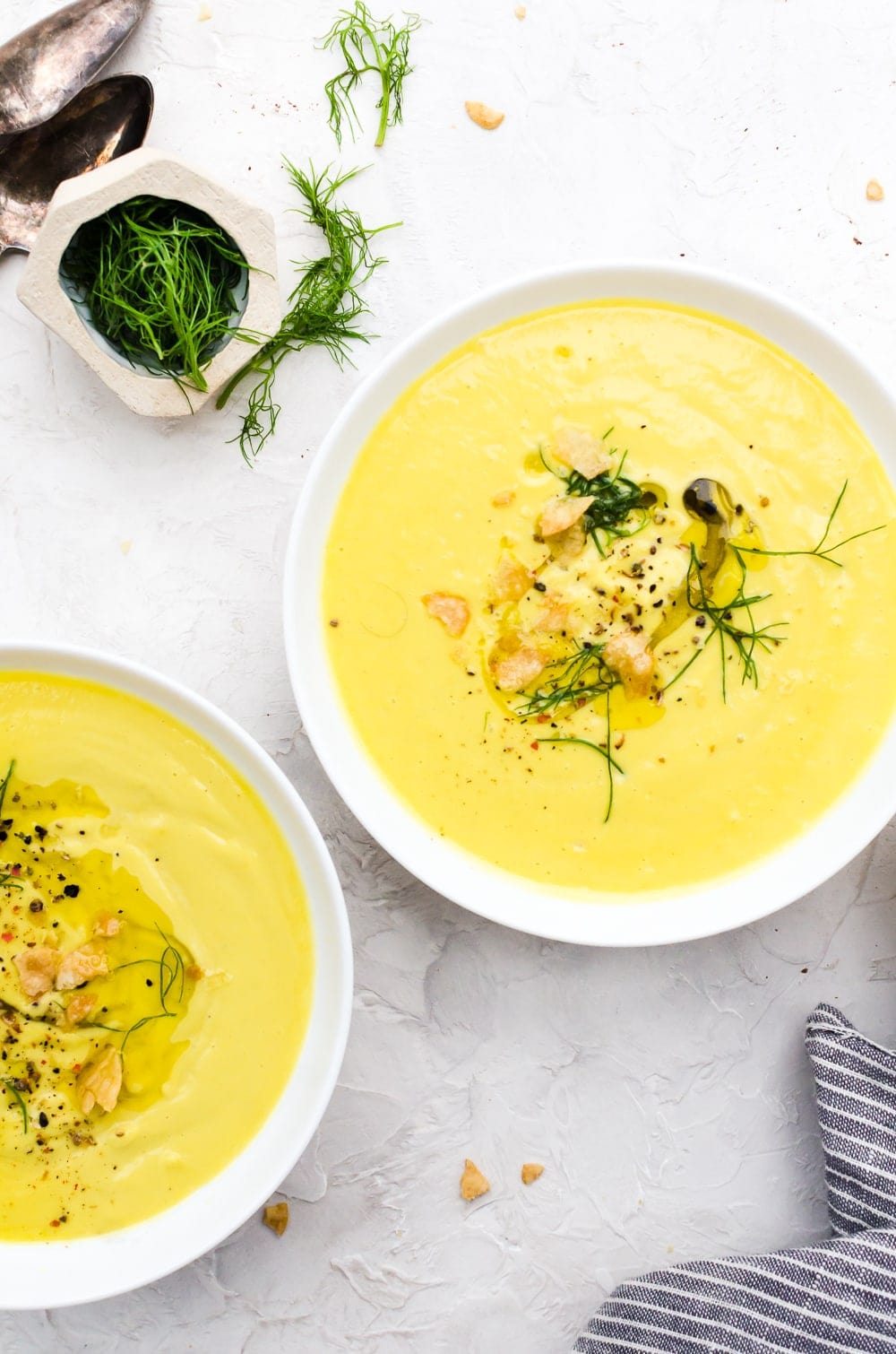 close up creamy cauliflower soup in bowls