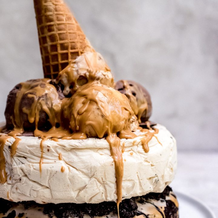 chocolate peanut butter ice cream cake with ice cream cone and peanut butter sauce