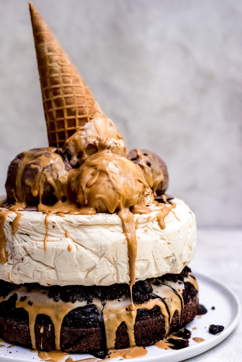 chocolate peanut butter ice cream cake with ice cream cone and peanut butter sauce