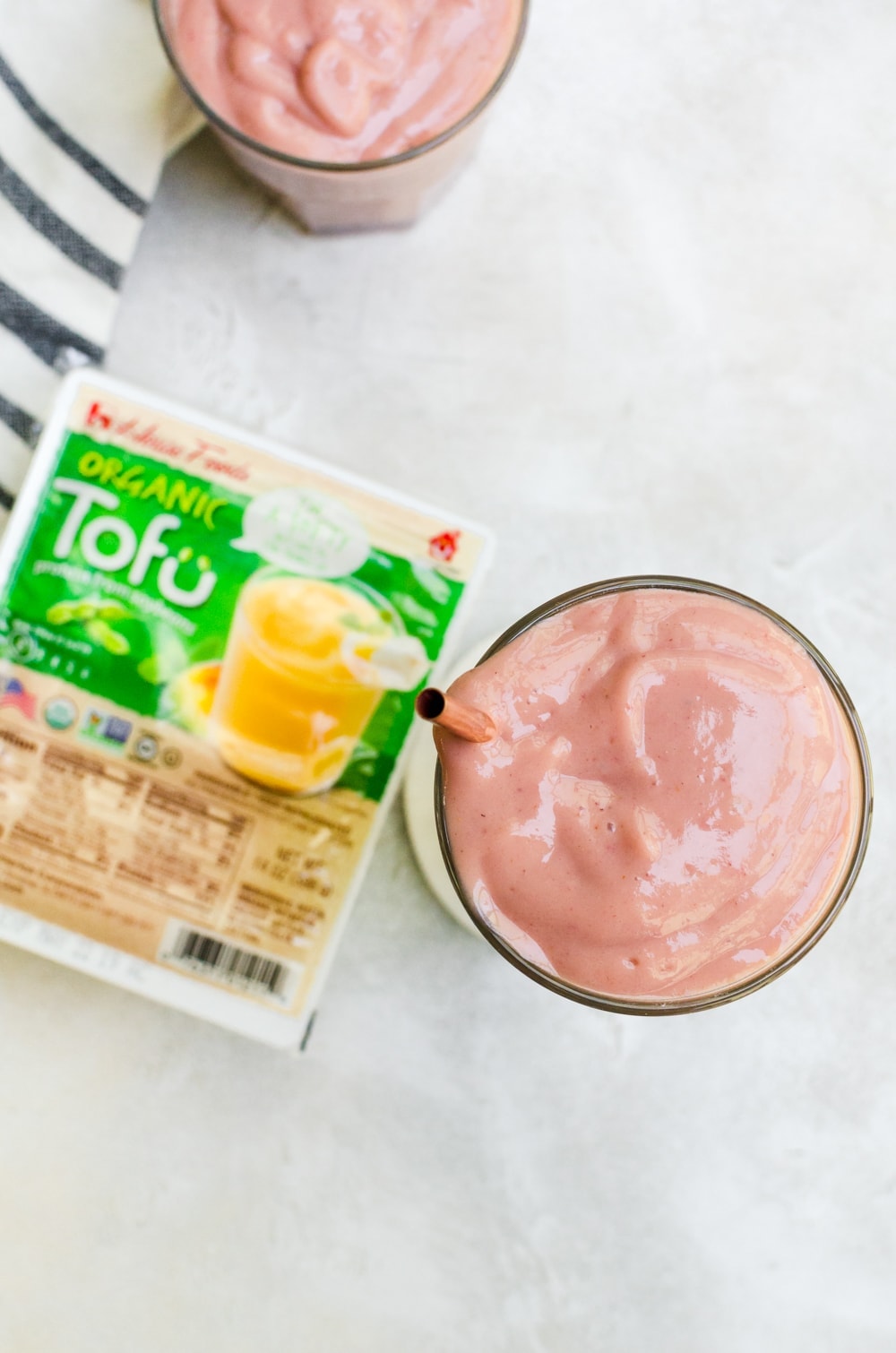 overhead strawberry papaya smoothie next to tofu