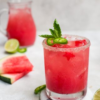 watermelon margarita with sliced watermelon and pitcher