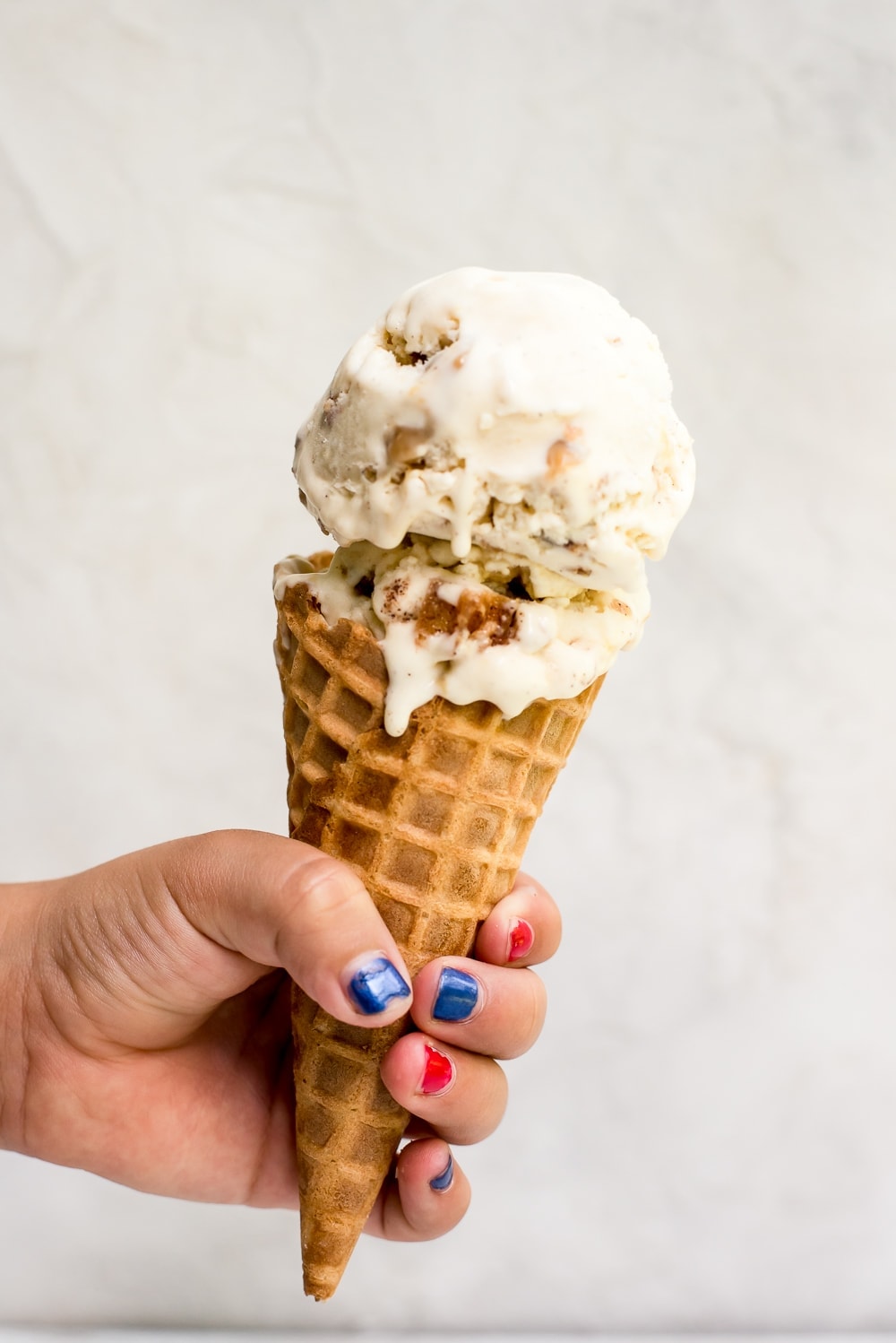 churro ice cream in a cone dripping