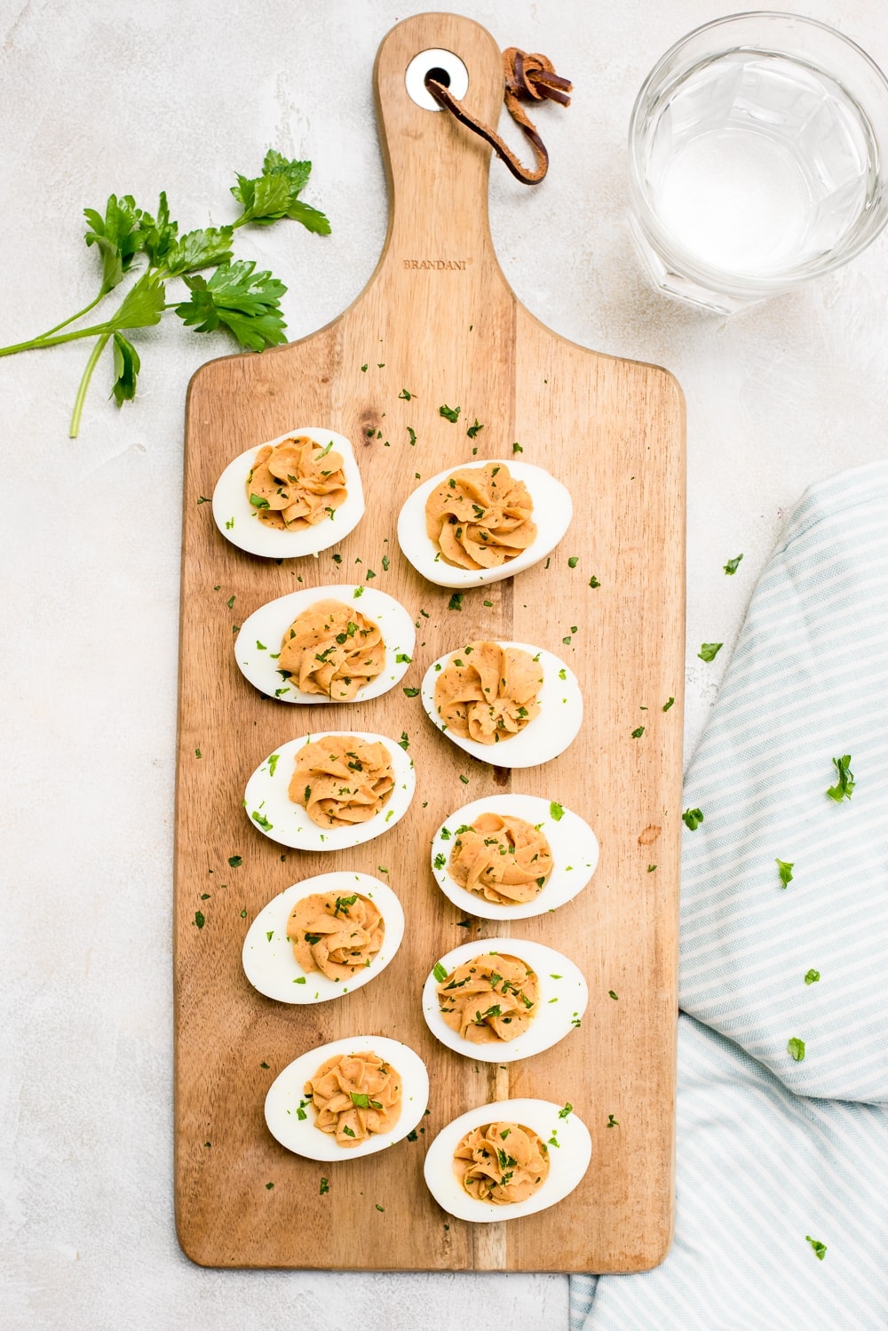 bbq deviled eggs on wood cheeseboard with spices