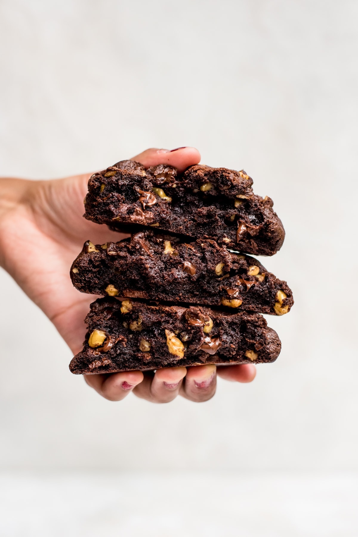 stack of giant double chocolate cookies in a hand